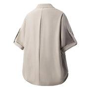 A light beige short-sleeve button-up shirt shown from the back, featuring a central seam and sleeve button details, set against a plain white background.