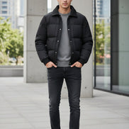 A black men's puffer jacket with a ribbed collar and snap-button front, shown on a light gray background with a promotional badge on the left highlighting 90% duck down content.