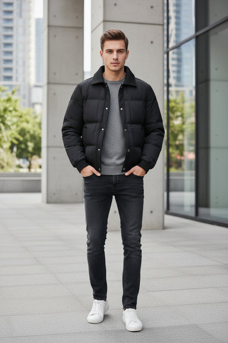 A black men's puffer jacket with a ribbed collar and snap-button front, shown on a light gray background with a promotional badge on the left highlighting 90% duck down content.