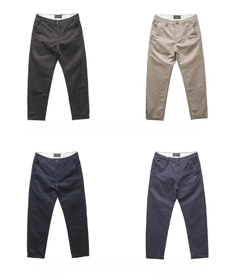 Four pairs of slim-fit chinos shown flat against a white background, arranged in a 2x2 grid. The top-left pair is charcoal gray, 