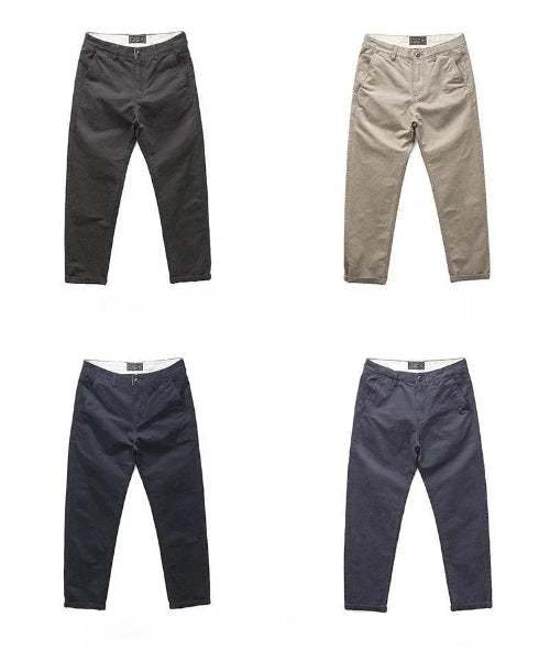 Four pairs of slim-fit chinos shown flat against a white background, arranged in a 2x2 grid. The top-left pair is charcoal gray, 