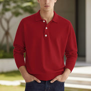Red long-sleeve polo shirt worn by a person on a beige background