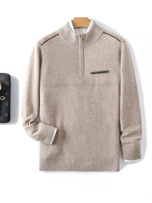 Beige quarter-zip mock-neck sweater with a chest pocket, displayed against a white background with a wooden hanger visible behind the collar.