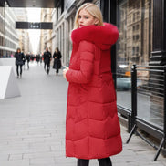 Woman wearing a red puffer coat on a city street