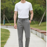 Gray pants worn by a person on a white background