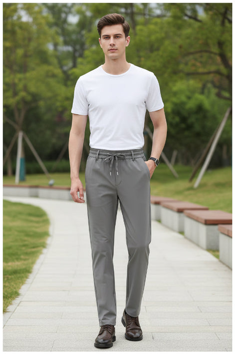 Gray pants worn by a person on a white background