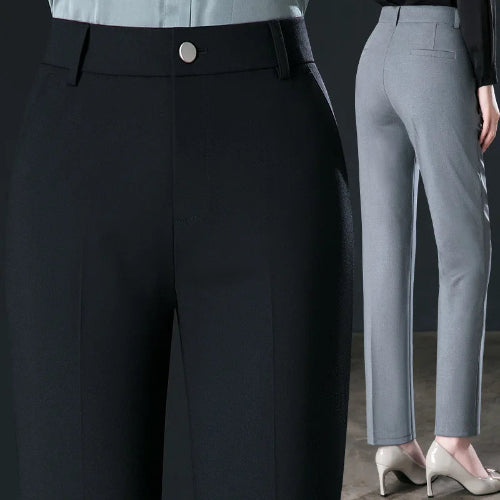 Close-up of black pants with a button and a person wearing gray pants.