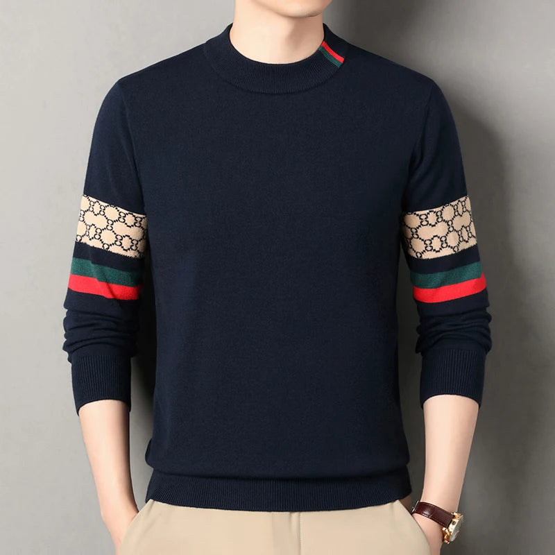 Navy sweater with patterned sleeves on a plain background