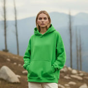 Person wearing a bright green hoodie on a white background