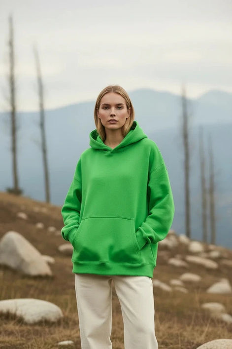 Person wearing a bright green hoodie on a white background