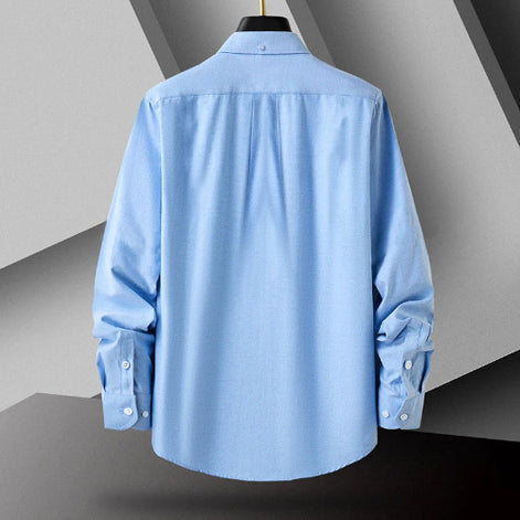 Light blue shirt on a mannequin against a gray geometric background