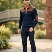 Navy sweater with brown collar and arm patches on a white background