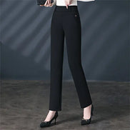 Black pants worn by a person on a gray background