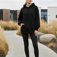 Black hoodie worn by a person on a white background