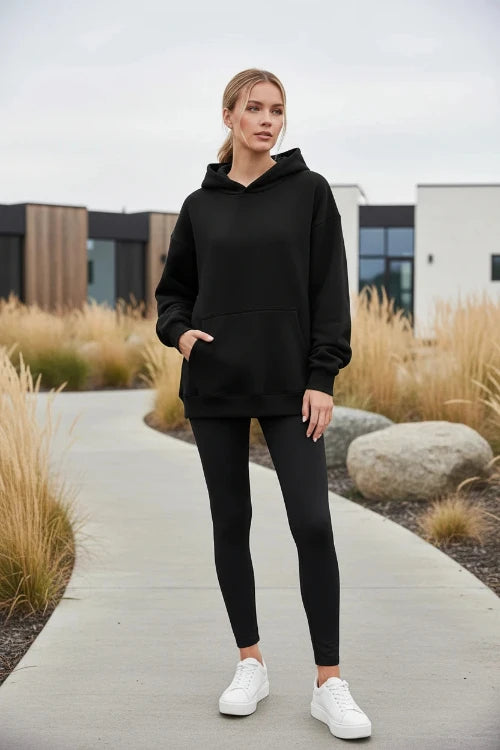 Black hoodie worn by a person on a white background