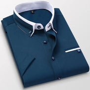 Folded blue dress shirt with white collar on a light gray background