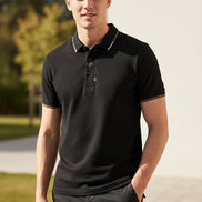 Close-up of a black polo shirt with a brand logo on a gray background