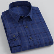 A folded blue plaid long-sleeve dress shirt with dark buttons, displayed on a clean white background.