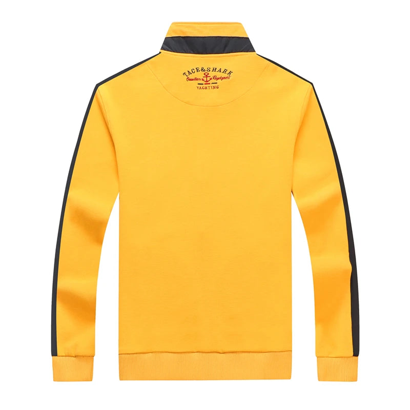 Yellow sweatshirt with black stripes on sleeves and collar, featuring a brand logo on the back, on a white background.