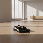 Black dress shoes on a wooden floor with 'Joker Tide Shoes' branding.
