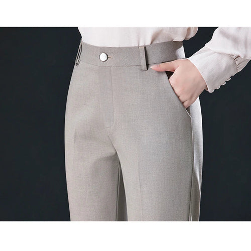 Gray pants worn with a white shirt on a black background