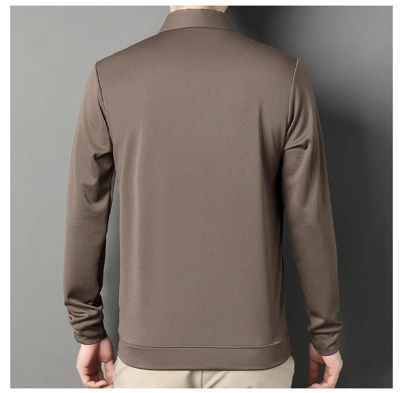 A man wearing a brown long-sleeve quarter-zip pullover jacket, shown from the back against a dark gray studio background.