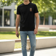 Black t-shirt with a brown patch featuring a cartoon character on a hanger.
