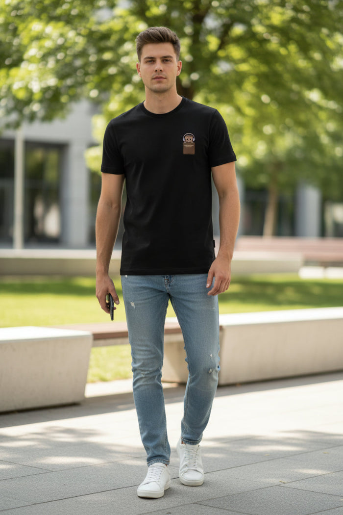 Black t-shirt with a brown patch featuring a cartoon character on a hanger.