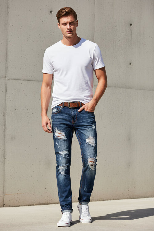 Distressed blue jeans with a white background