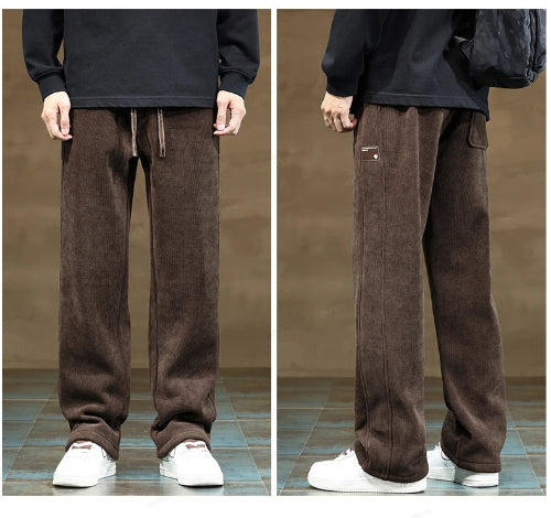 Brown corduroy pants worn by a person on a tiled floor with a neutral background
