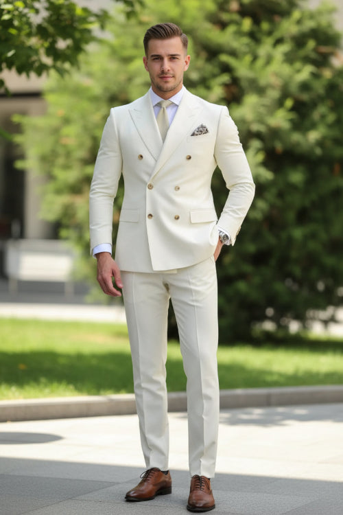 Man wearing a cream double-breasted suit with a blurred green background