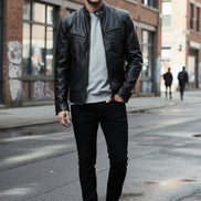 Black leather jacket worn by a person on a white background