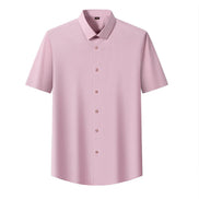 A light pink short-sleeve button-up shirt with a classic pointed collar, displayed on a clean white background.