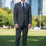 Gray suit with blue tie and brown shoes on a white background