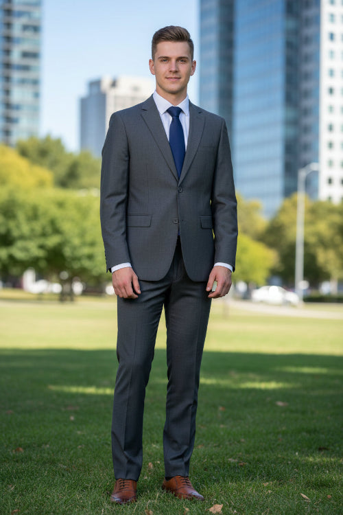Gray suit with blue tie and brown shoes on a white background