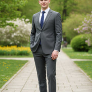 Gray suit with blue tie and brown shoes on a white background