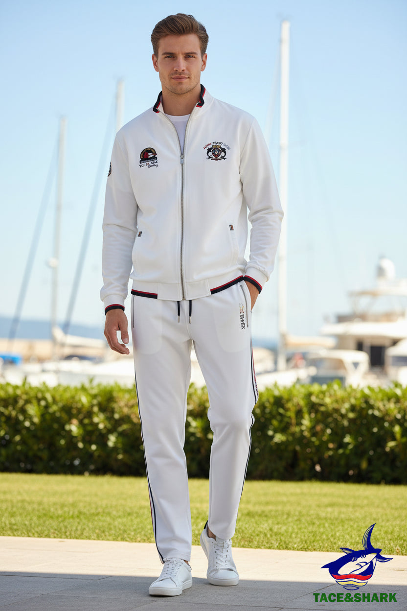 A men's two-piece tracksuit set consisting of a white zip-up jacket and matching sweatpants. The jacket features red and black trim on the collar, cuffs, and hem, along with a shark logo on the left chest.
