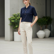 Navy blue shirt with gold buttons on a light gray surface