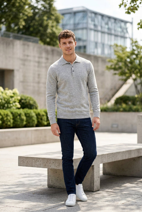 Gray sweater on a hanger against a gray background
