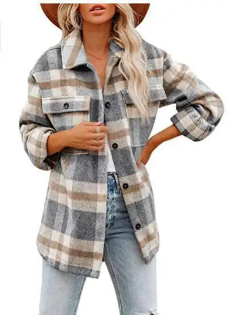 Woman wearing a gray and cream plaid shirt with a white top and jeans, against a white background.