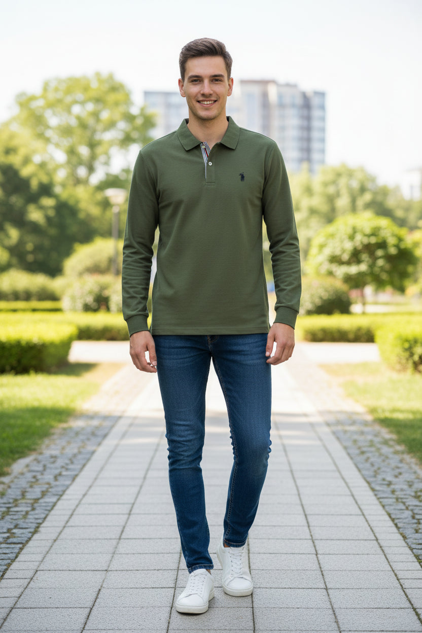 Green long-sleeve polo shirt on a hanger with other colored shirts in the background.