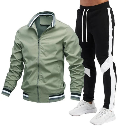 A men's two-piece tracksuit set featuring an olive green zip-up bomber jacket with striped ribbed trim and black track pants 
