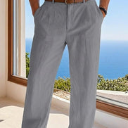 Person wearing gray pants with a blurred scenic background