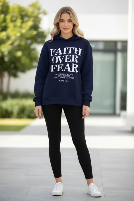 Navy blue hoodie with 'Faith Over Fear' text on a wooden surface with shoes and a cone.