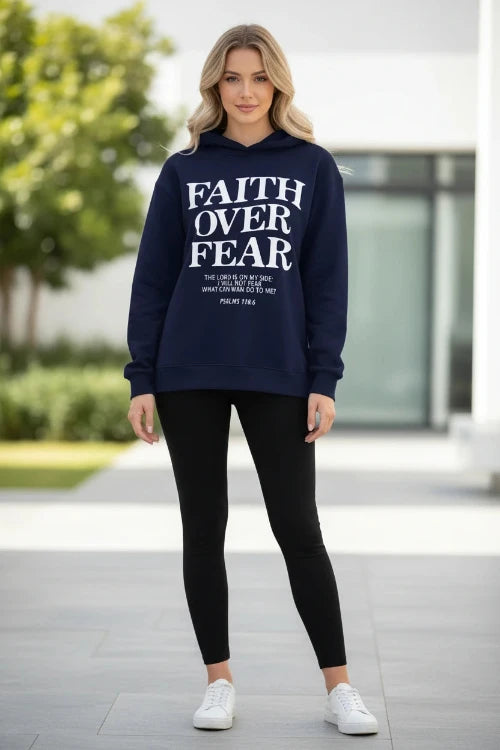 Navy blue hoodie with 'Faith Over Fear' text on a wooden surface with shoes and a cone.