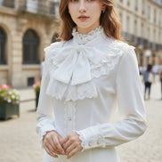 White blouse with lace details on a white background