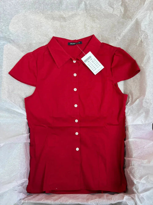 Red dress with a tag on a textured white background