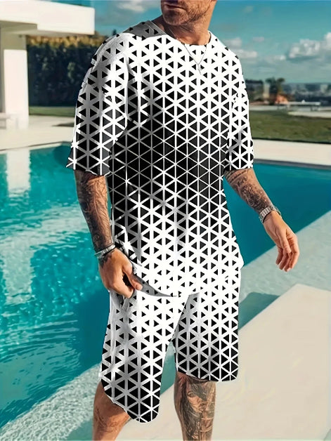 A man wearing a matching black and white geometric patterned t-shirt and shorts set, standing next to a swimming pool.