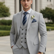 Gray suit with striped tie and pocket square on a white background