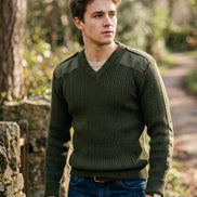 Green sweater with shoulder pads on a white background